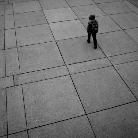 <p>A person crossing a plaza in Toronto.<br /></p>