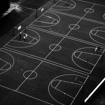 <p>Basketball courts shot from an urban cable car.</p>
