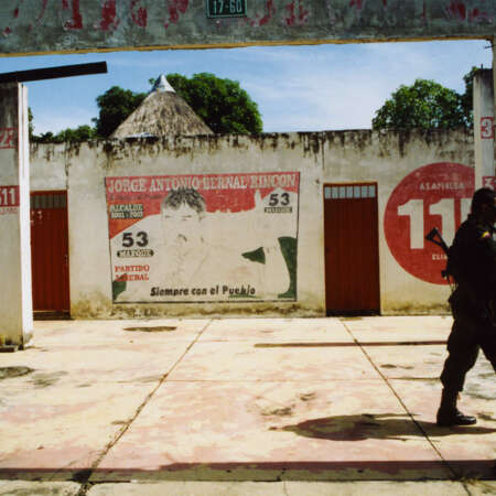 <p>Two well-armed national police officers patrol the streets of Tame, passing sun-beaten election murals for the then-mayor.</p>