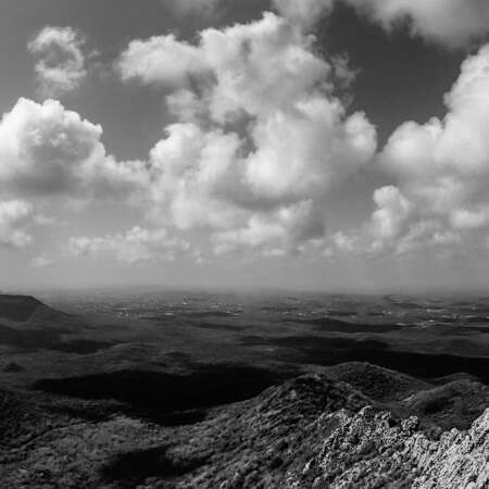 <p>Clouds cast shadows over the arid landscape of the Christoffelpark, as seen from the highest point in Curaçao.</p>