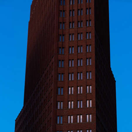 <p>A view of the Kollhoff Tower, a distinctive skyscraper occupying a sharply angular corner at Berlin's Potsdamer Platz.</p>