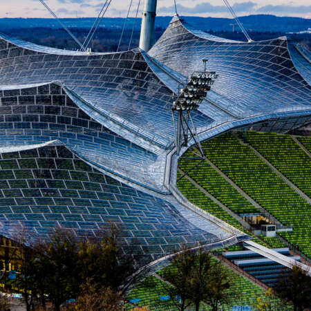 <p>The unique contours of the Munich Olympic Stadium, designed by architect Günther Behnisch and engineer Frei Otto for the summer games of 1972. The famous suspended roof — a vast tent of glass panels held aloft by steel cables and pillars — still looks futuristic almost 50 years after it was erected. </p>