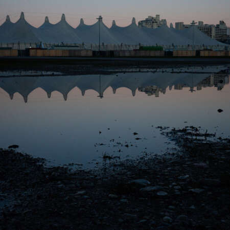 <p>Tents at the Theresienwiese – home to Munich's Oktoberfest – reflected in a puddle on a still morning.<br /></p>