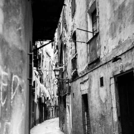 <p>A narrow street in the Barri Gòtic, the oldest quarter of Barcelona. Shot in the mid 1990s, when the post-Olympic boom was already changing the Catalan city, this photo shows a bygone era. You'd be hard-pressed to find a street in the Barri Gòtic that looks anything like this now.<br /></p>