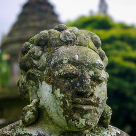<p>Lichen slowly covering a stone statue at the Pura Ulun Danu Beratan, a major temple on Bali.</p>