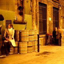 <p>Empty kegs provide impromptu seating as the night wears on in Dublin's Dame Lane.</p>