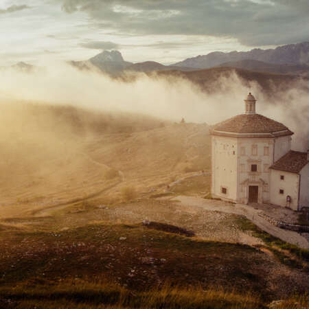 <p>Mist engulfs the church of Santa Maria della Pietà, with the peak of Gran Sasso in the distance.</p>