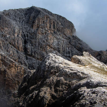 <p>A pair of hikers heading toward the Sas de Pütia / Peitlerkofel peak, visible during a brief clearing in the mists and clouds that were whipping around up there. </p>