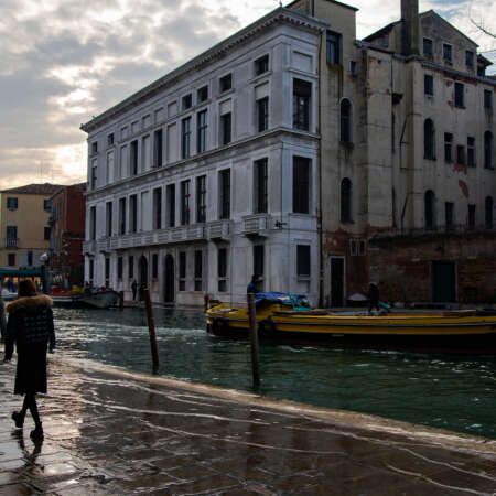 <p>People walk along the fondamenti either side of the Canale di Cannaregio, one of Venice's larger canals. The wake from passing boats washes up over the walkways. </p>