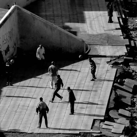 <p>A group of men practice football along Rabat's tattered beachfront.</p>