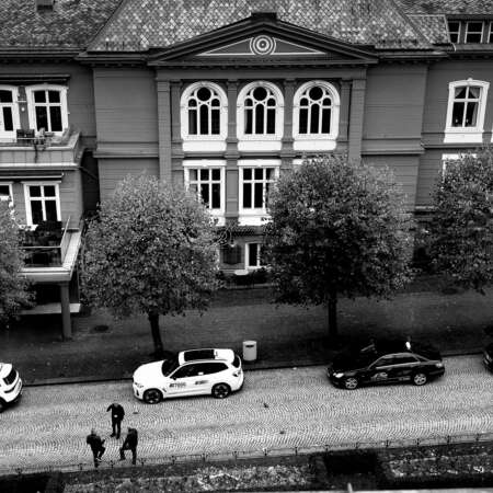 <p>A trio of taxi drivers chat while waiting for a fare.</p>