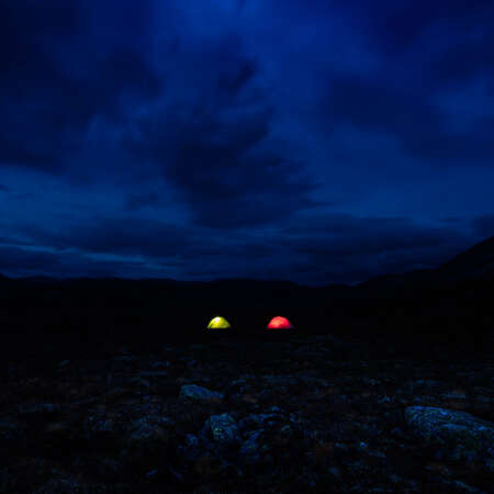 <p>Darkness envelopes two tents in the Norwegian wilderness.</p>