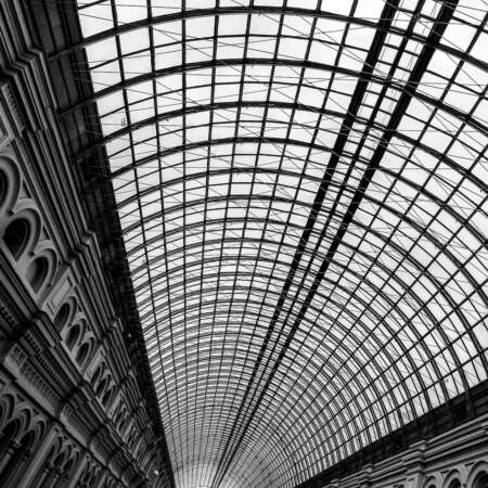 <p>Moscow's GUM runs the length of one side of Red Square. It dates from the late 19th Century, and was designed by Alexander Pomerantsev and Vladimir Shukhov. Shukhov in particular engineered this stunning glass roof, which covers several storeys of passages and created a climate-controlled shopping experience long before the suburban shopping mall concept. <br /></p><p>The name GUM, which stands for Main Universal Store (Главный универсальный магазин), was given to the facility during the Soviet period, and has stuck around since. Today, it really is a shopping mall – but with some serious architectural pedigree. </p>