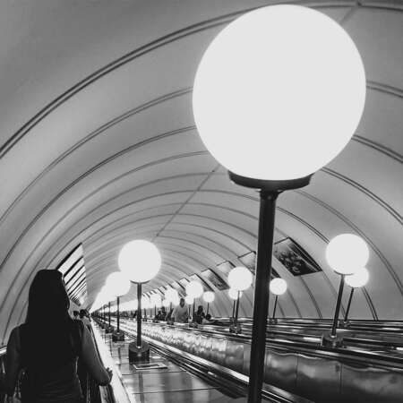 <p>Passengers descending into and ascending out of one of Moscow's very deep metro stations.</p>