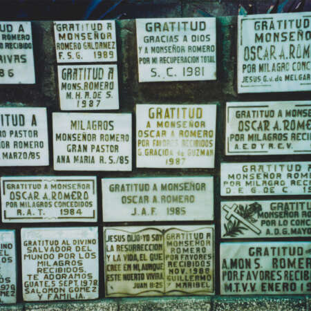 <p>Plaques expressing gratitude to Archbishop Oscar Romero fill a low wall outside the chapel where he was murdered. Renowned for his embrace of the poor, and an outspoken critic of the Salvadoran government and widespread human rights abuses in his country, Romero was shot and killed by right-wing death squads while conducting mass on 24 March 1980. <br /></p>