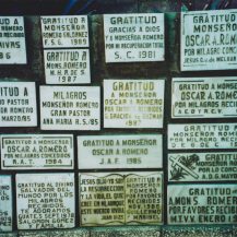 <p>Plaques expressing gratitude to Archbishop Oscar Romero fill a low wall outside the chapel where he was murdered. Renowned for his embrace of the poor, and an outspoken critic of the Salvadoran government and widespread human rights abuses in his country, Romero was shot and killed by right-wing death squads while conducting mass on 24 March 1980. <br /></p>