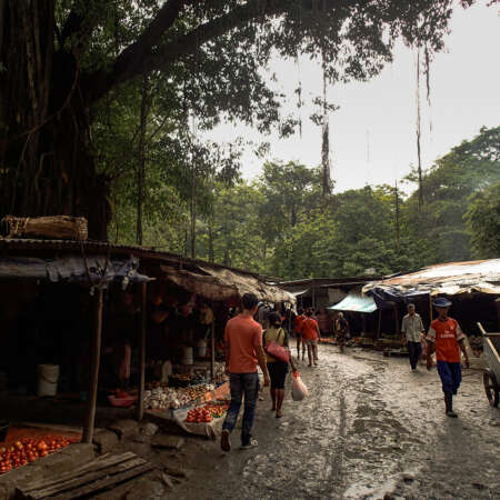 <p>Shoppers at a sprawling market in Dili, shortly after a rainstorm.</p>