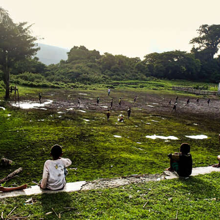 <p>A small crowd watches their neighbours playing football, somewhere in Timor-Leste's east. </p>