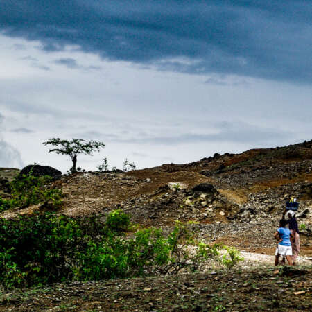 <p>Two people walking along a path somewhere near Laga, in eastern Timor-Leste.</p>