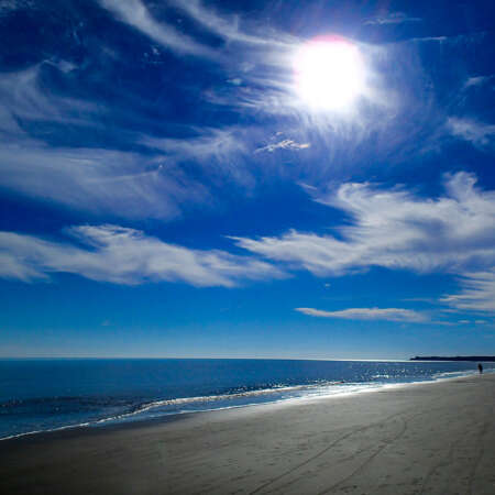 <p>A beautiful winter day on the beach, complemented by wispy clouds</p>