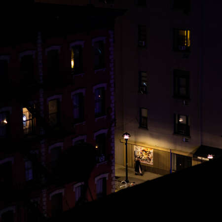 <p>A person out for a night stroll in Manhattan.</p>
