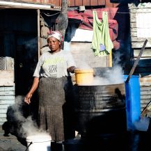 <p>A woman washing clothes on a winter morning in Langa. </p>