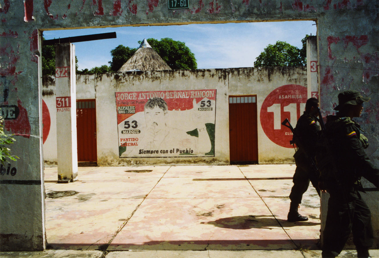 <p>Two well-armed national police officers patrol the streets of Tame, passing sun-beaten election murals for the then-mayor.</p>
